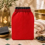 Original Moroccan exfoliating fiber glove in a luxury Moroccan spa setting with traditional bath accessories