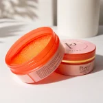 Opened Pastel Orange & Vitamin C Moroccan soap scrub with rich oily texture in a luxury skincare setup